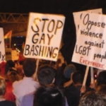 This image is from the article; it shows people holding signs demanding rights for the diverse SOGIESC community